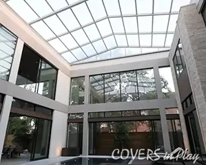 Retractable roof pool enclosure over the pool